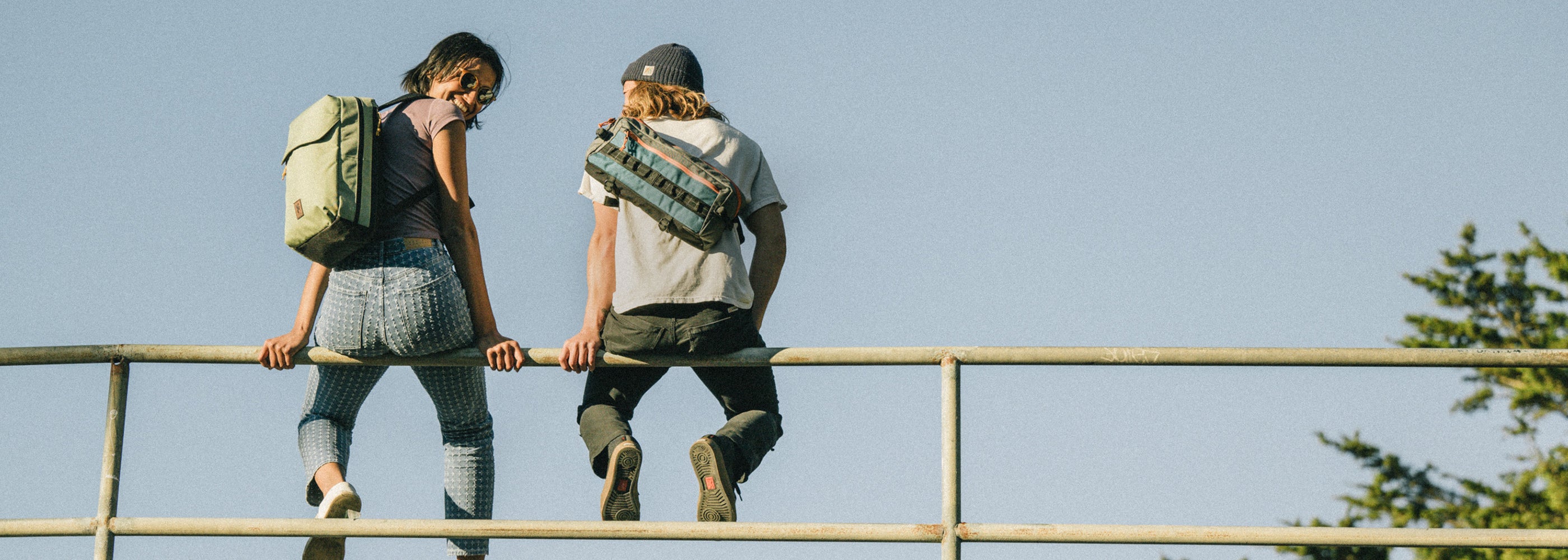 Careers banner two people sitting on a fence wearing their Chrome Packs desktop size